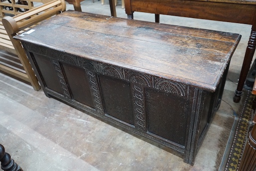 An 18th century and later carved panelled oak coffer, width 145cm, depth 58cm, height 61cm